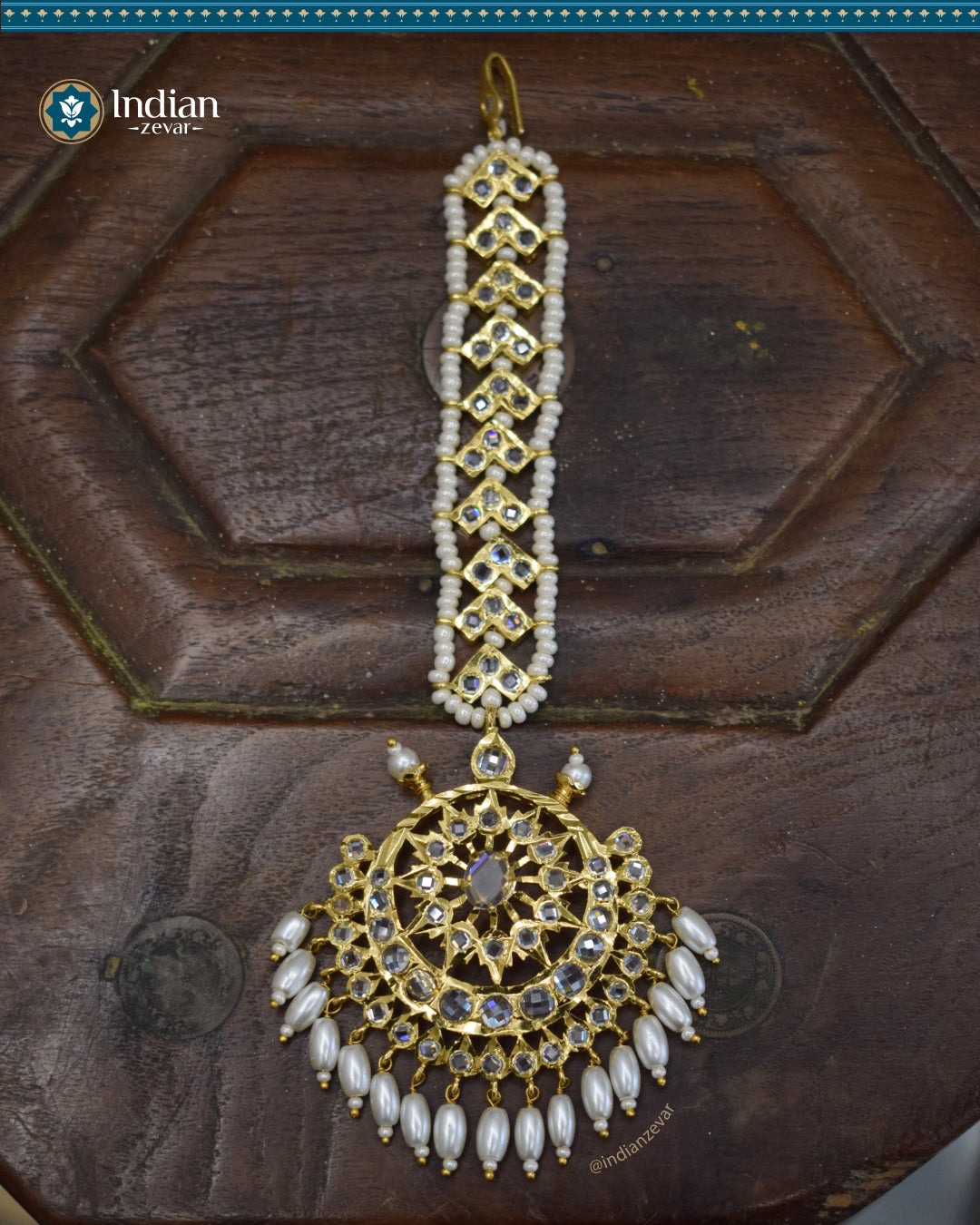 A close-up image of a Hyderabadi Jadau maang tika, adorned with CZ Polki stones, faux freshwater pearls, and intricate gold-plated alloy work