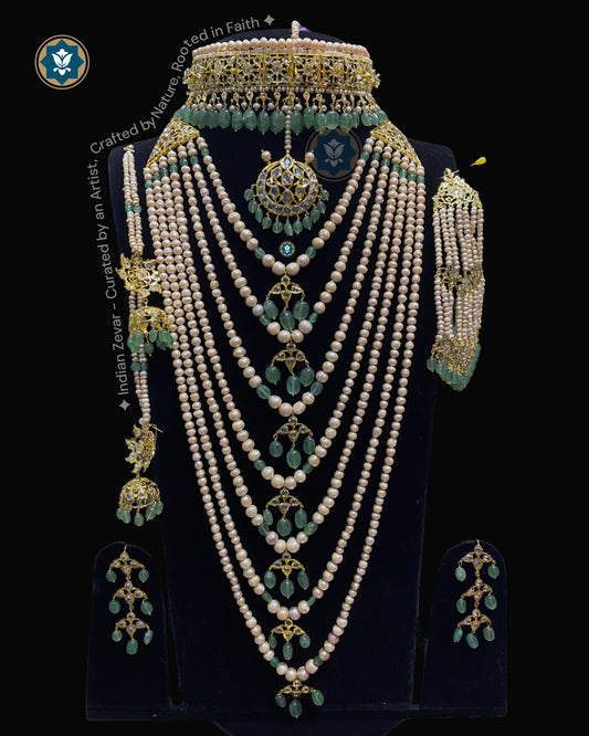 Handcrafted Hyderabadi Jadau bridal jewellery set featuring a Sathlada pearl necklace, Jadau bridal choker, matching earrings, Karanphool Jhumka with Sarasari, Maang Tika, Jhumar (Passa), Cubic Zirconia Flat Cut Polki, natural Green Aventurine gemstones, real antique freshwater pearls, and premium gold-polished alloy by Indian Zevar.