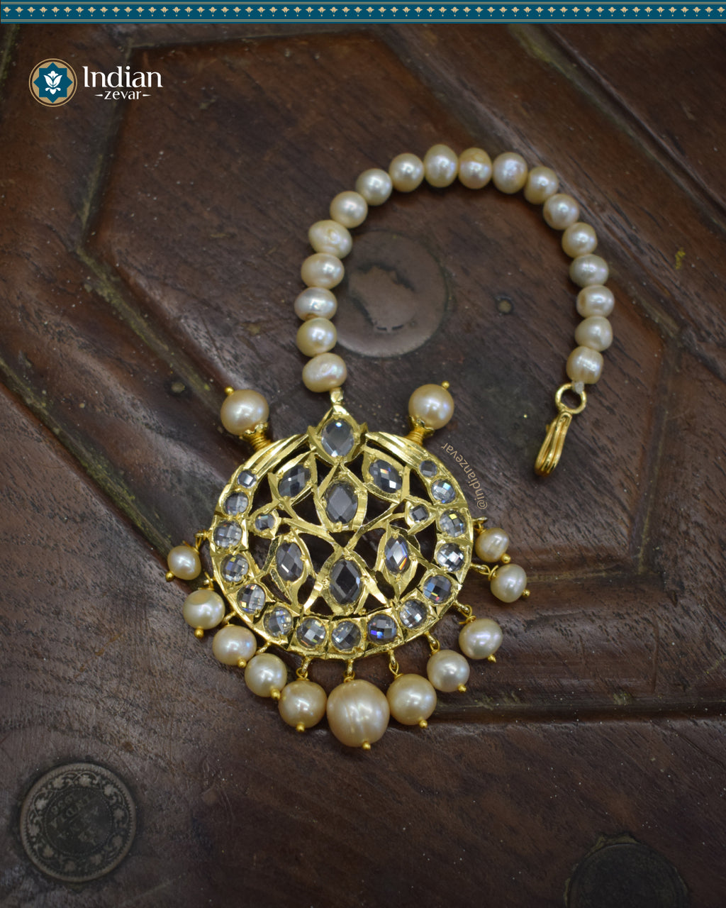 A close-up image of a Hyderabadi Jadau maang tika, adorned with CZ Polki stones, real freshwater pearls, and intricate gold-plated alloy work.
