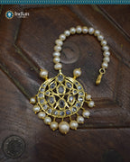 A close-up image of a Hyderabadi Jadau maang tika, adorned with CZ Polki stones, real freshwater pearls, and intricate gold-plated alloy work.