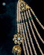 Seven-stringed Hyderabadi Sathlada necklace with gradated freshwater pearls and emerald droplets.