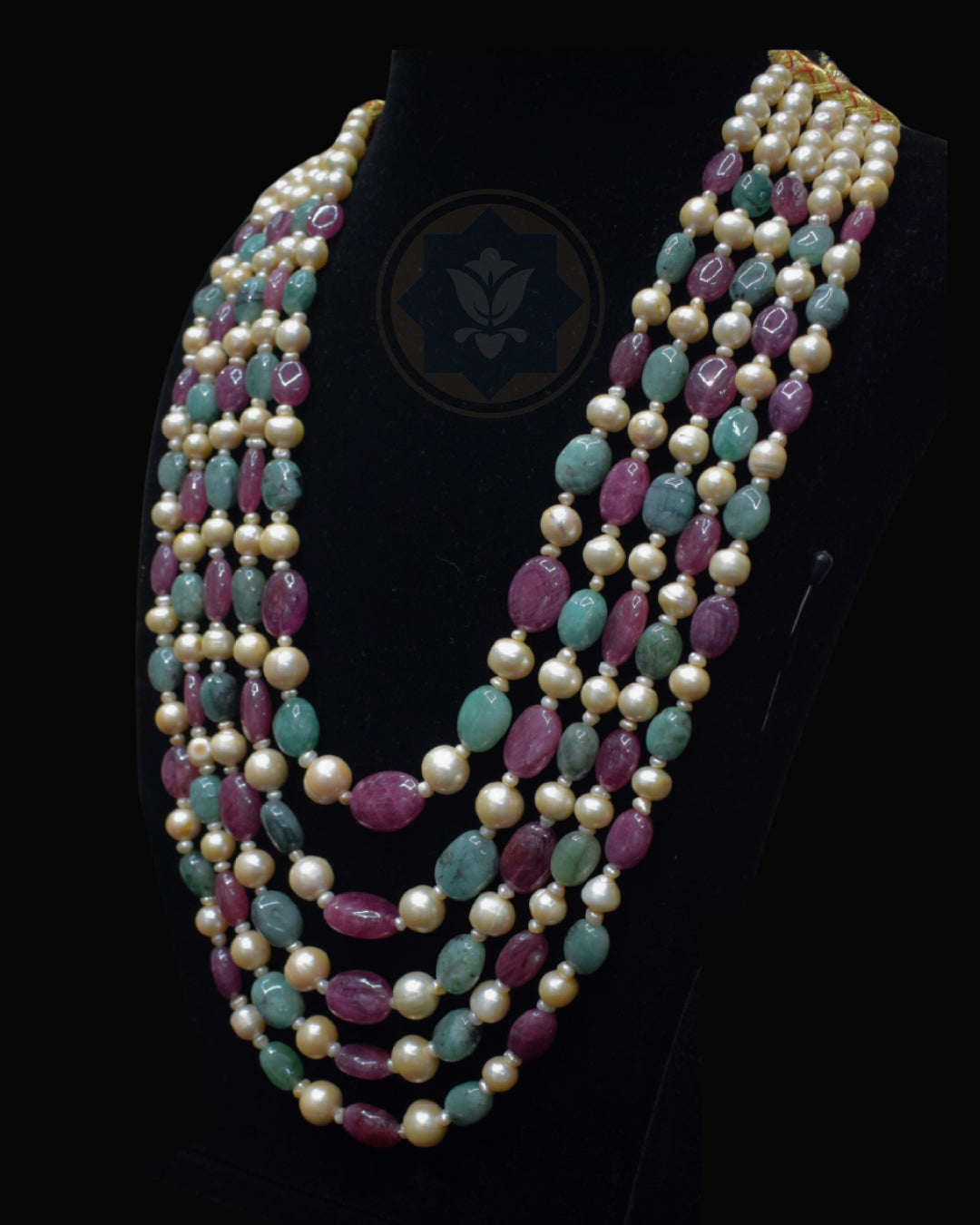 Side view of Indian Zevar five-string necklace set featuring big-size ruby beads, big-size emerald beads, freshwater pearls, CZ Polki and matching earrings.