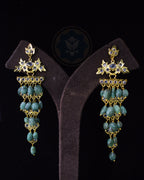Indian Zevar Angoor Goshe chandelier earrings featuring real Brazilian Emeralds, CZ Flat Cut Polki and premium gold polish on a copper base.