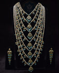Indian Zevar Grand Emerald Sathlada with seven strings of freshwater pearls, emerald Jadau hangings, CZ Polki and matching Angoor Goshe chandelier earrings.