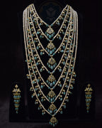 Indian Zevar Grand Emerald Sathlada with seven strings of freshwater pearls, emerald Jadau hangings, CZ Polki and matching Angoor Goshe chandelier earrings.