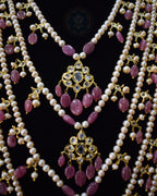 Close-up view of Indian Zevar Grand Ruby Sathlada with seven strings of real freshwater pearls, Bangkok Ruby GF beads, CZ Polki, Jadau hangings and matching Angoor Goshe chandelier earrings.