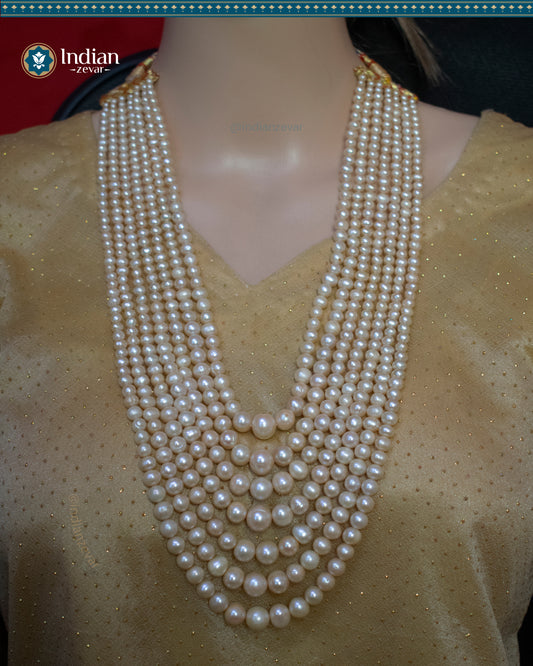 A beautiful gradation pearl sathlada necklace with seven strings of real freshwater pearls, perfect for adding a touch of elegance to any outfit.