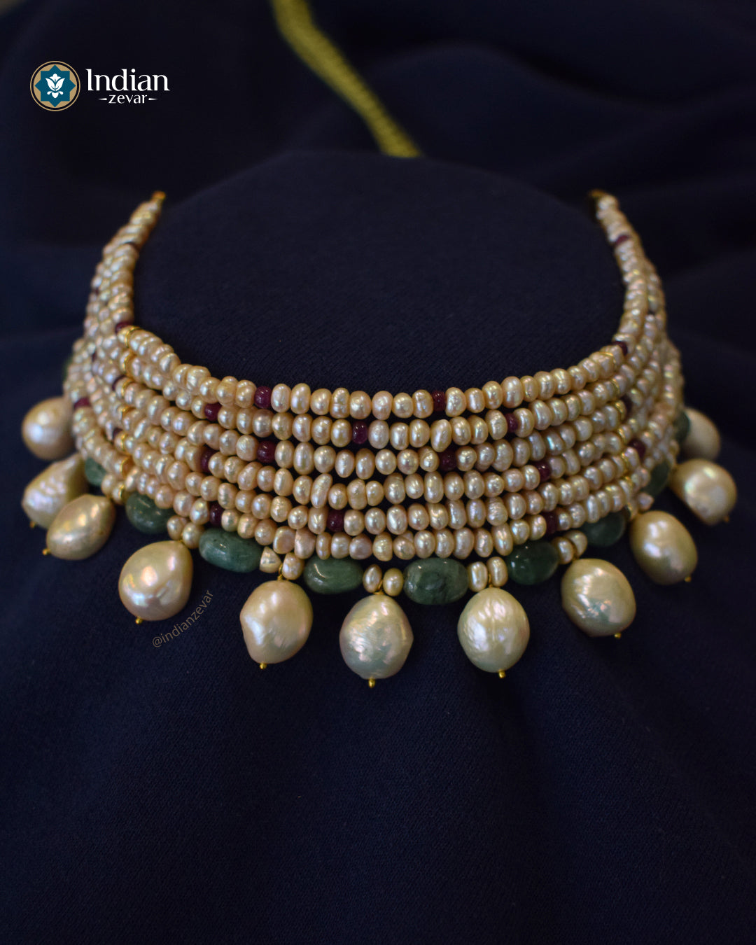 Seven-line choker with freshwater pearls, Ruby and Emerald beads, Baroque pearls, and gold-toned metal connectors finished with a green braided cord, handcrafted by Indian Zevar.