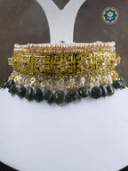 A classic Hyderabadi choker set featuring real freshwater old pearls and dark emeralds, handcrafted with 6 crt gold plating for a luxurious touch.