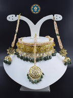 Handmade classic Hyderabadi choker set featuring real freshwater old pearls and dark emeralds. 6 carat gold plated Gulband Jadavi lachcha design with matching Maang Tikka and Jhumka earrings. Adorned with CZ polki stones. Made in India with unique irregularities that add to its natural beauty.